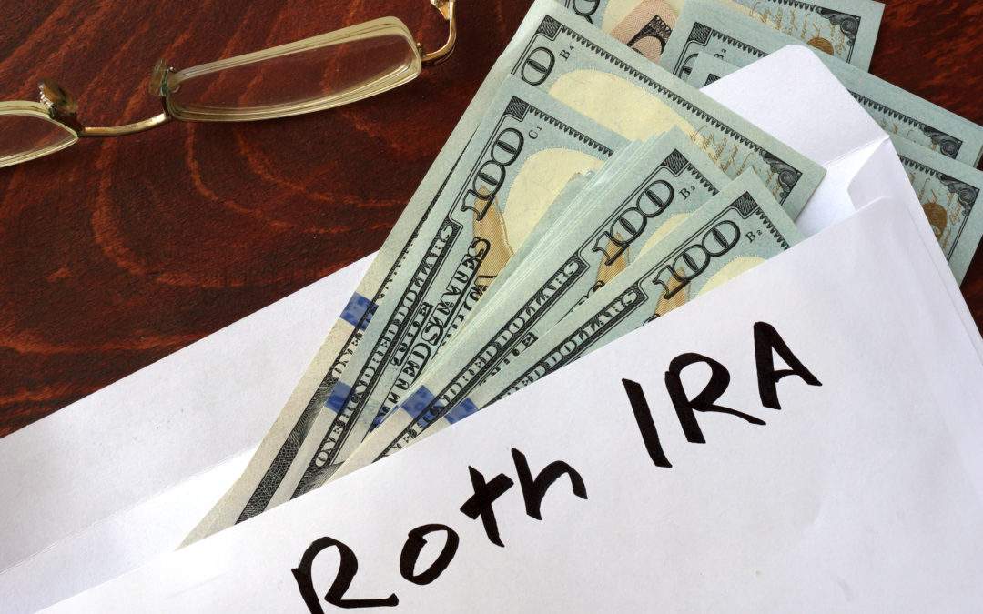 roth ira written on an envelope with dollars. savings concept.